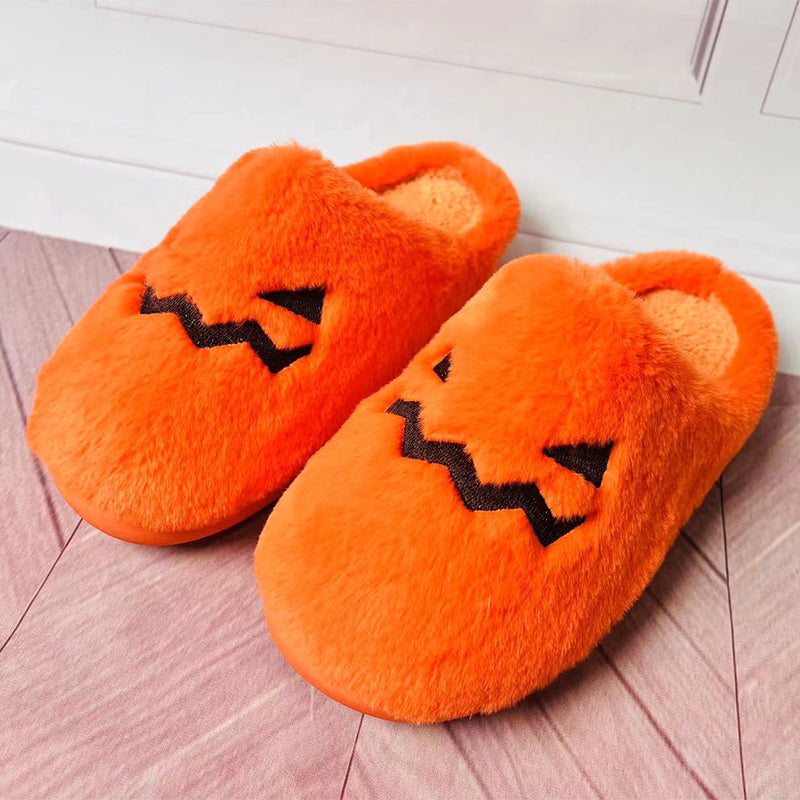 Pair of orange jack-o'-lantern house slippers