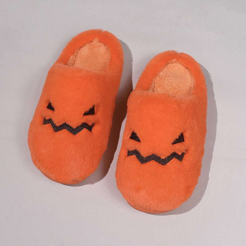 Orange pumpkin face slippers top view