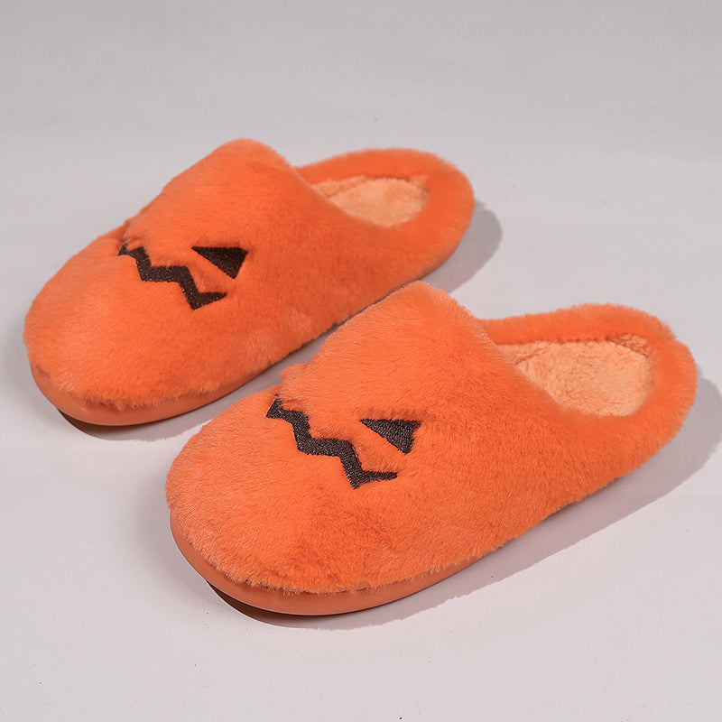 Fuzzy orange pumpkin slippers angled view