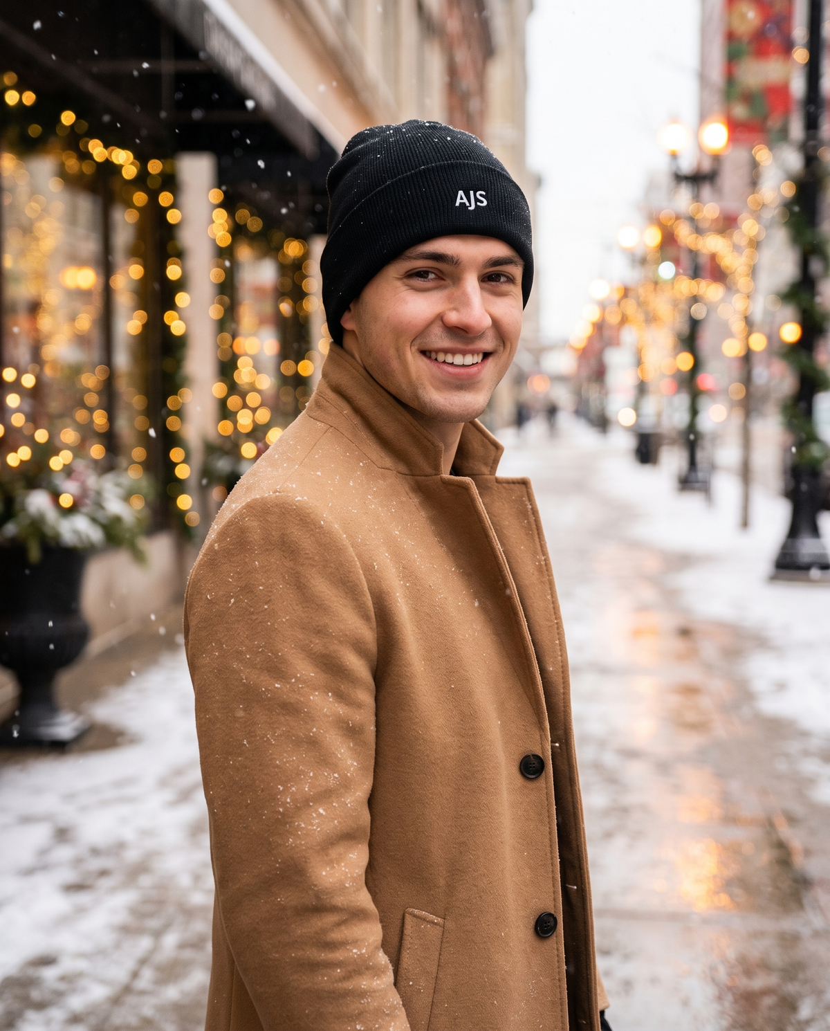 Man wearing custom embroidered initials beanie in snow