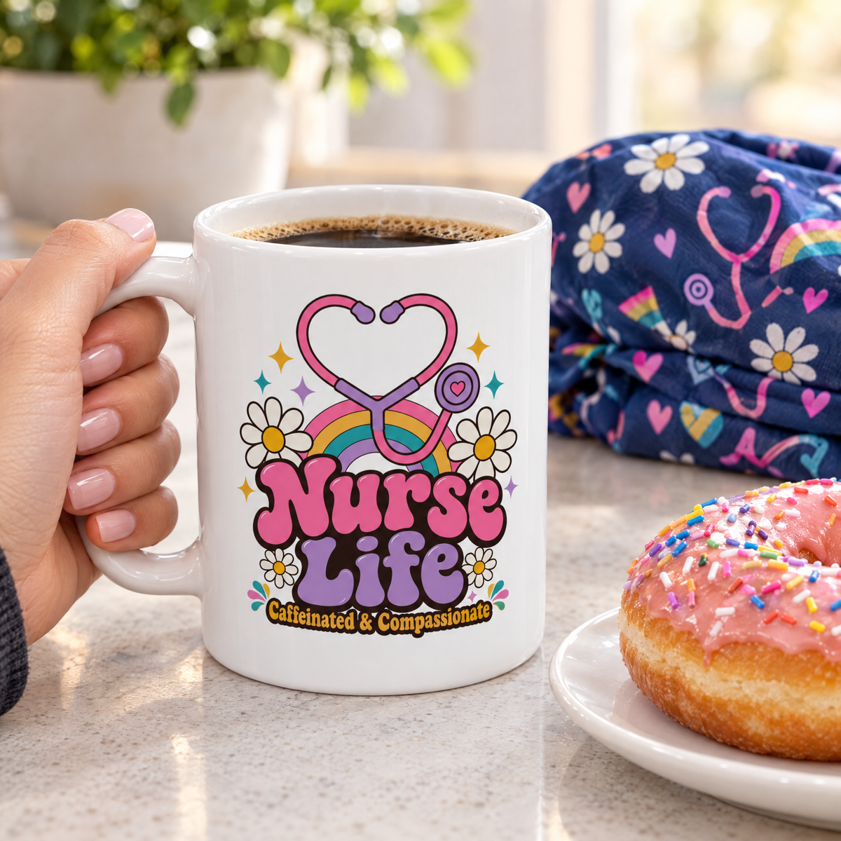 Close-up of the Nurse Life mug with coffee beside a scrub cap and a sprinkle donut