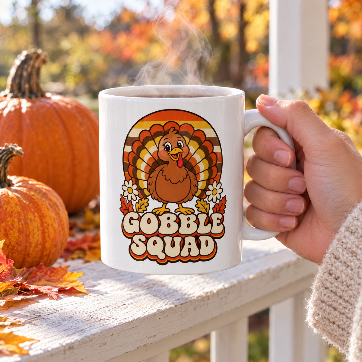 Gobble Squad mug of steaming coffee on a porch railing with pumpkins